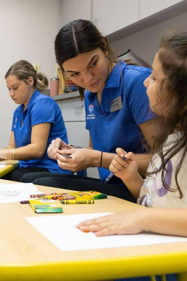 Clinic students working with elementary aged children